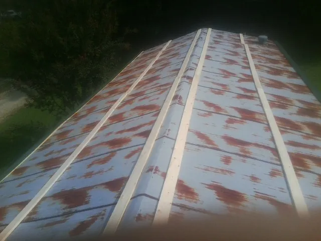 Rusted metal roof panels with new wood purlins before replacement — Storm Damage Roof Repair in Floral City by Roofing Brothers